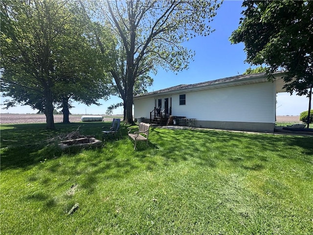 rear view of property with a lawn and french doors