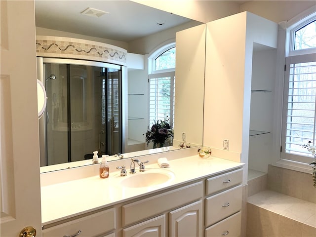 bathroom featuring vanity and a shower