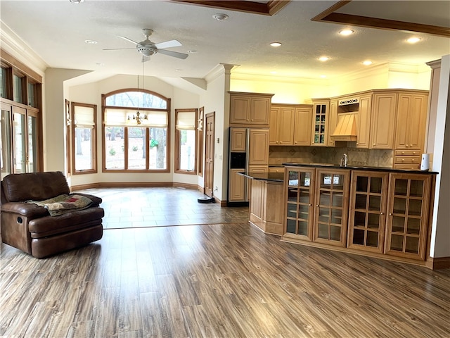 interior space featuring ornamental molding, dark hardwood / wood-style floors, and ceiling fan with notable chandelier