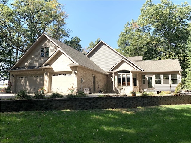 view of front of property with a garage and a front lawn