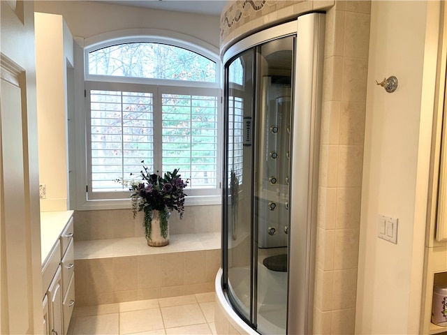 bathroom featuring vanity, an enclosed shower, tile patterned flooring, and a wealth of natural light