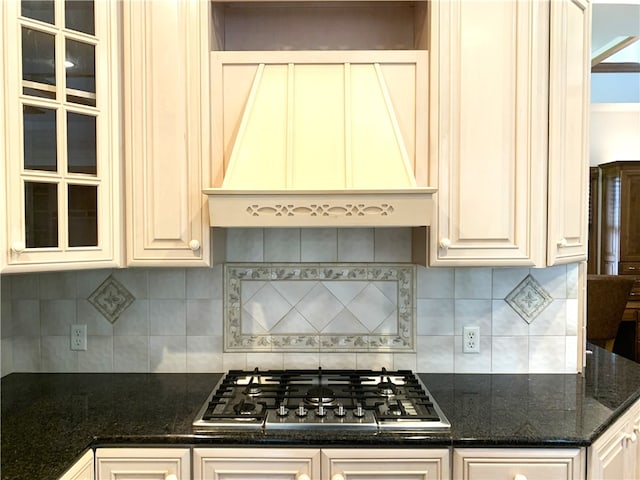 kitchen with custom exhaust hood, tasteful backsplash, and stainless steel gas stovetop