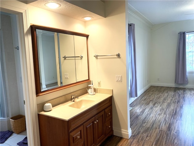 bathroom featuring vanity, hardwood / wood-style floors, and a textured ceiling