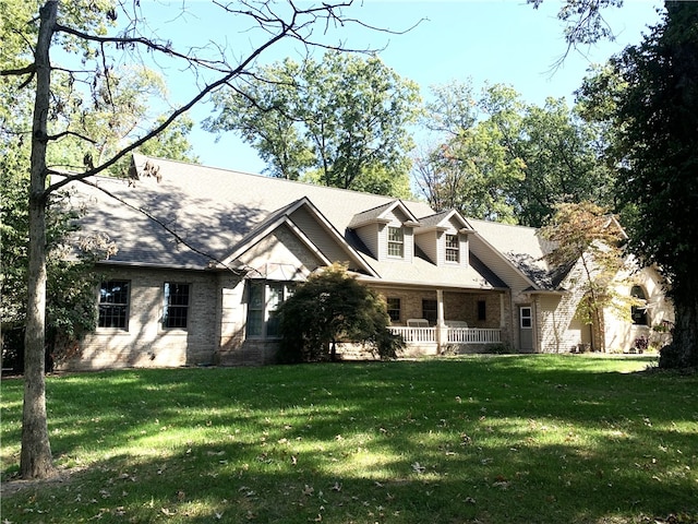 cape cod-style house with a front lawn