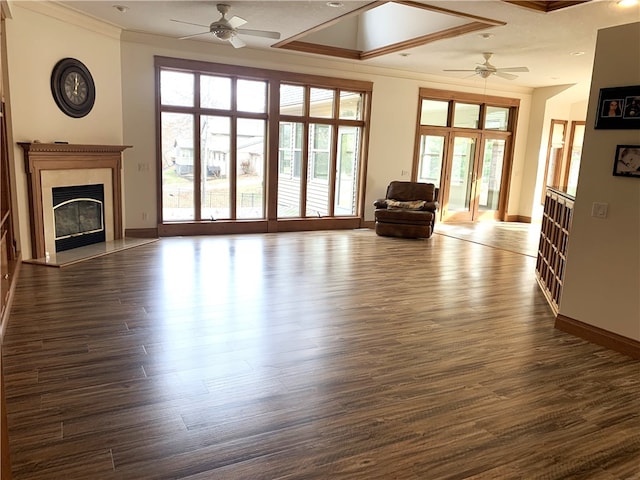 unfurnished living room featuring crown molding, dark hardwood / wood-style floors, and ceiling fan