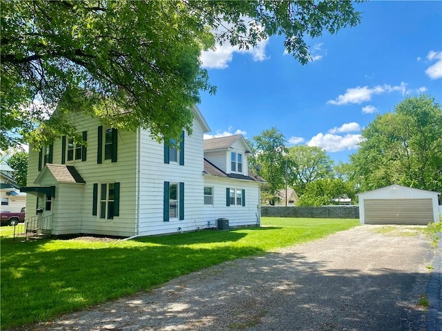 view of property exterior featuring a garage, an outbuilding, fence, central AC unit, and a yard