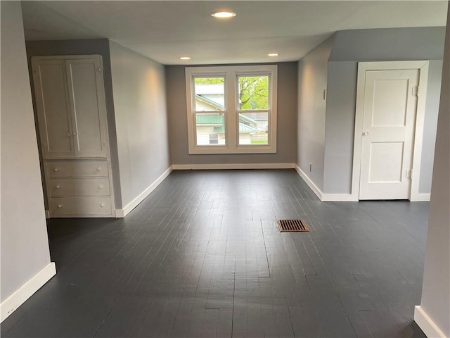 unfurnished room featuring baseboards, recessed lighting, visible vents, and dark wood-style floors