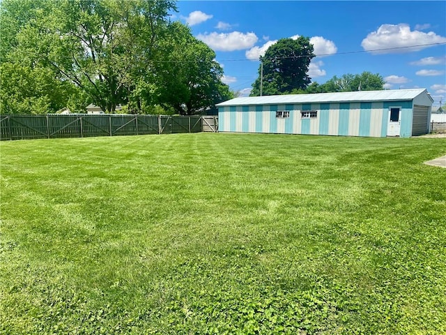 view of yard with an outbuilding and a fenced backyard