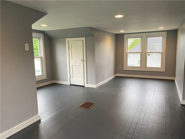 spare room with baseboards, visible vents, recessed lighting, and dark wood-style floors
