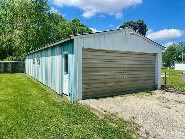 detached garage featuring fence