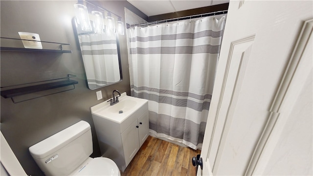 1006 Chicago Ave, Danville, IL 61832 - full bath featuring wood finished floors, vanity, toilet, and a shower with curtain