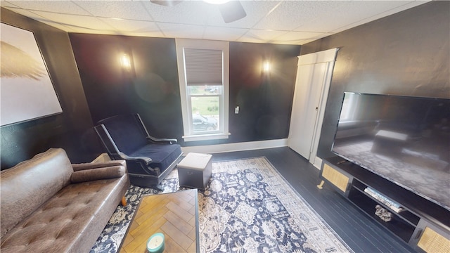 1006 Chicago Ave, Danville, IL 61832 - living room featuring a drop ceiling, ceiling fan, baseboards, and dark wood-type flooring