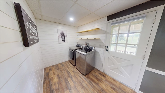 1006 Chicago Ave, Danville, IL 61832 - laundry area featuring independent washer and dryer, wood walls, and light wood-style floors