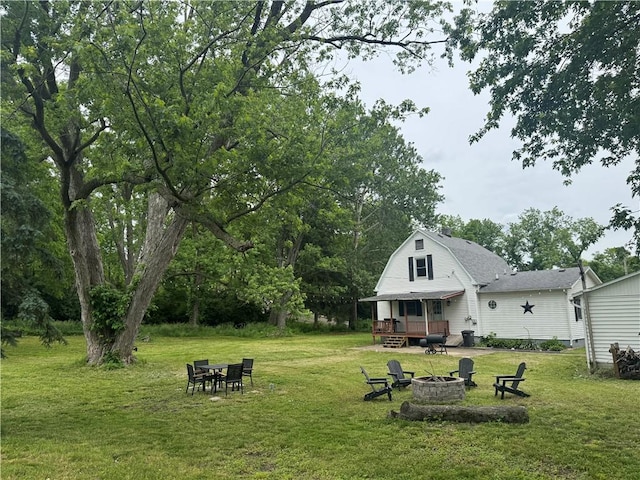 1006 Chicago Ave, Danville, IL 61832 - rear view of house with a fire pit, a yard, and a gambrel roof