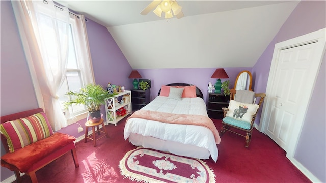 bedroom featuring carpet floors, vaulted ceiling, baseboards, and ceiling fan