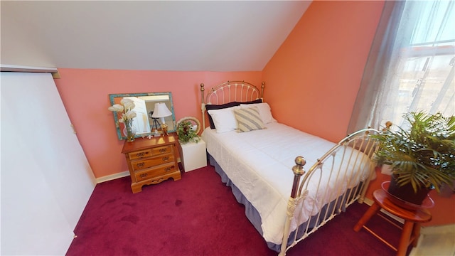 carpeted bedroom featuring lofted ceiling