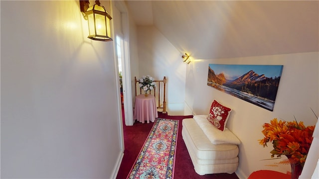 interior space featuring lofted ceiling, carpet floors, and an upstairs landing