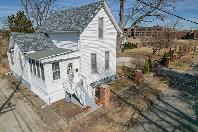 view of front of home with a shingled roof