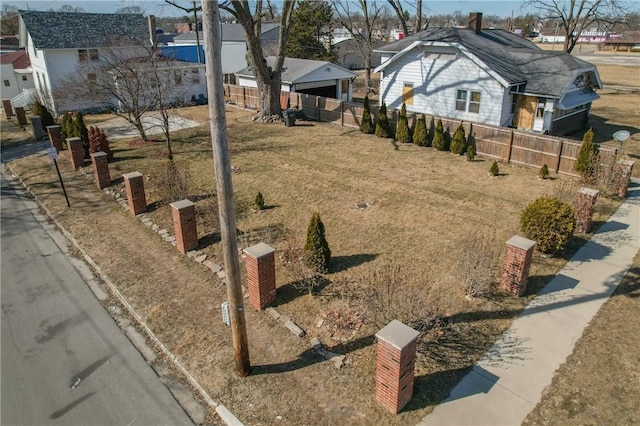 view of yard featuring fence and a residential view