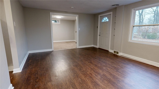 entrance foyer with visible vents, baseboards, and wood finished floors