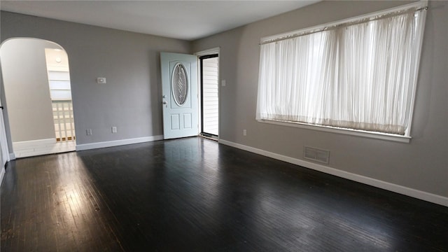 entryway with dark hardwood / wood-style flooring