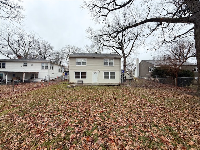 rear view of house with a fenced backyard