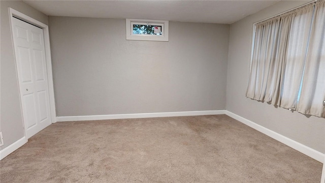 empty room with carpet floors and baseboards