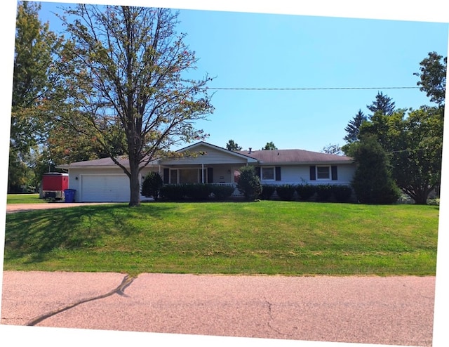 ranch-style house featuring a front yard and a garage