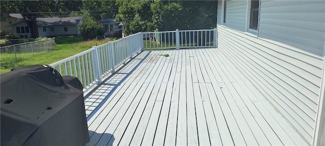 deck with area for grilling and a yard