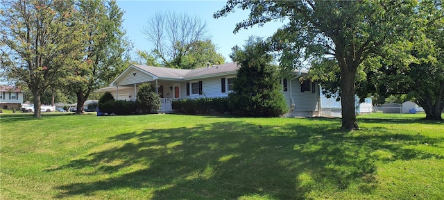 single story home with a front lawn and covered porch