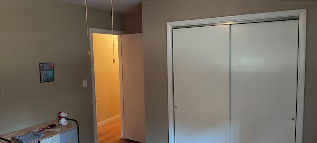 unfurnished bedroom featuring a closet and hardwood / wood-style flooring