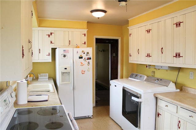 kitchen with white cabinets, white appliances, sink, and separate washer and dryer