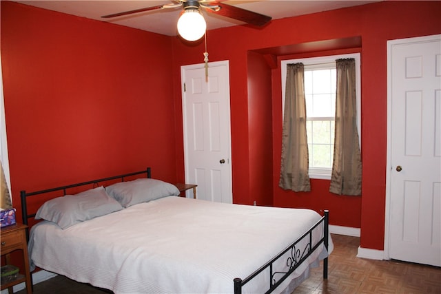 bedroom featuring parquet flooring and ceiling fan