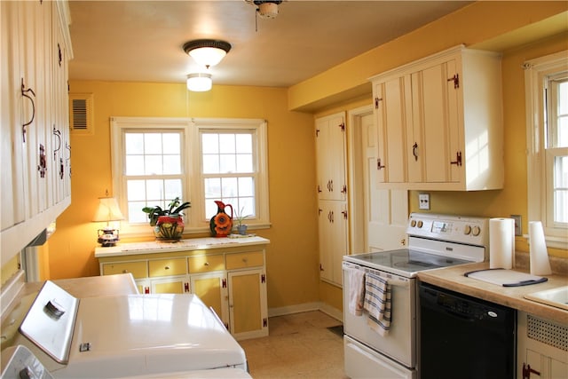 kitchen featuring white range with electric cooktop, dishwasher, a healthy amount of sunlight, and washing machine and dryer