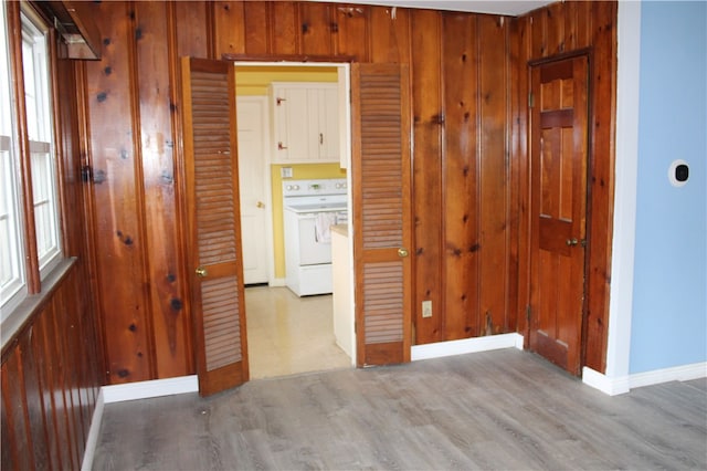 hall featuring hardwood / wood-style flooring and wood walls