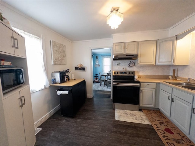 114 E 11th St, Georgetown, IL 61846 - kitchen with stainless steel appliances, under cabinet range hood, crown molding, dark wood finished floors, and light countertops