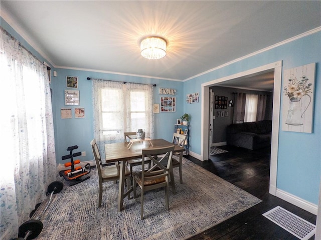 114 E 11th St, Georgetown, IL 61846 - dining room with crown molding, wood finished floors, and a chandelier