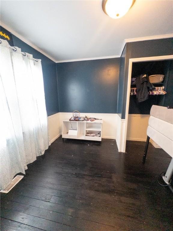 114 E 11th St, Georgetown, IL 61846 - empty room featuring hardwood / wood-style floors, ornamental molding, and a wainscoted wall