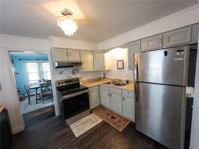 114 E 11th St, Georgetown, IL 61846 - kitchen featuring stainless steel appliances, under cabinet range hood, dark wood-style floors, crown molding, and light countertops