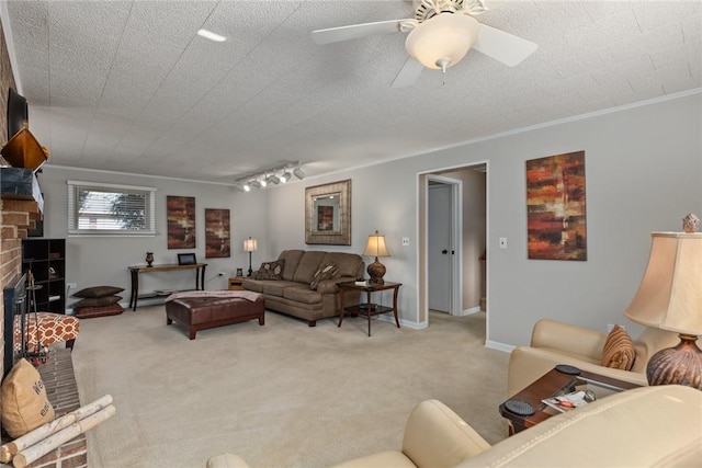 living area featuring crown molding, light carpet, a fireplace, and a textured ceiling