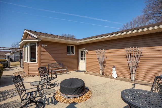 view of patio / terrace featuring an outdoor fire pit and fence