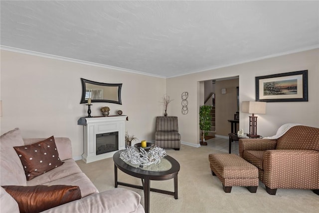 carpeted living room featuring baseboards, ornamental molding, and a glass covered fireplace