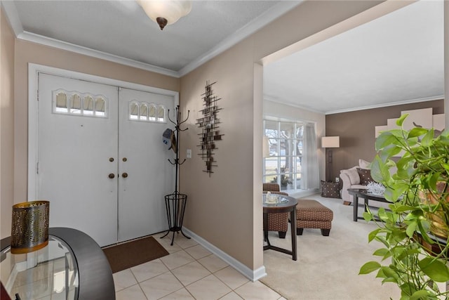 foyer entrance with ornamental molding, light carpet, and baseboards