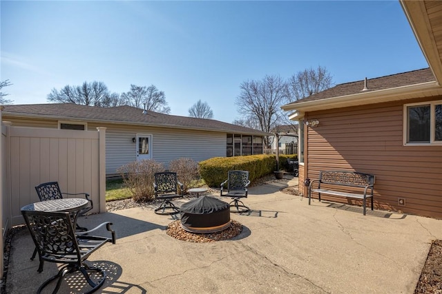 view of patio / terrace with fence and a fire pit