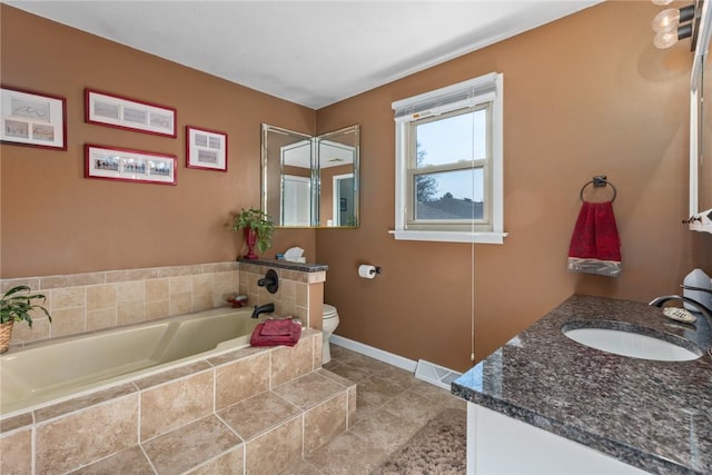 bathroom with a garden tub, visible vents, toilet, vanity, and baseboards