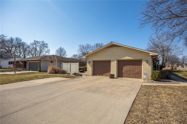 single story home featuring a garage and brick siding