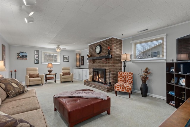 carpeted living area featuring a healthy amount of sunlight, a fireplace, visible vents, and crown molding