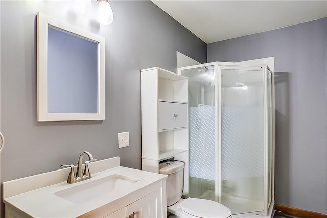 bathroom featuring vanity, toilet, and walk in shower