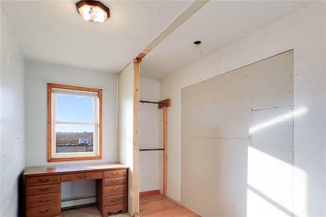 interior space featuring a baseboard radiator and light wood-type flooring