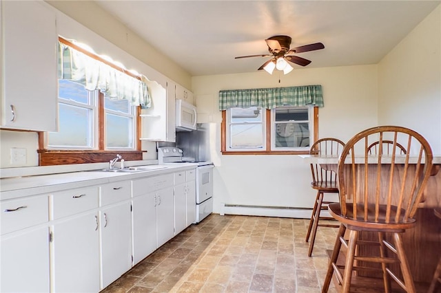 kitchen featuring white cabinetry, sink, a baseboard heating unit, ceiling fan, and white appliances